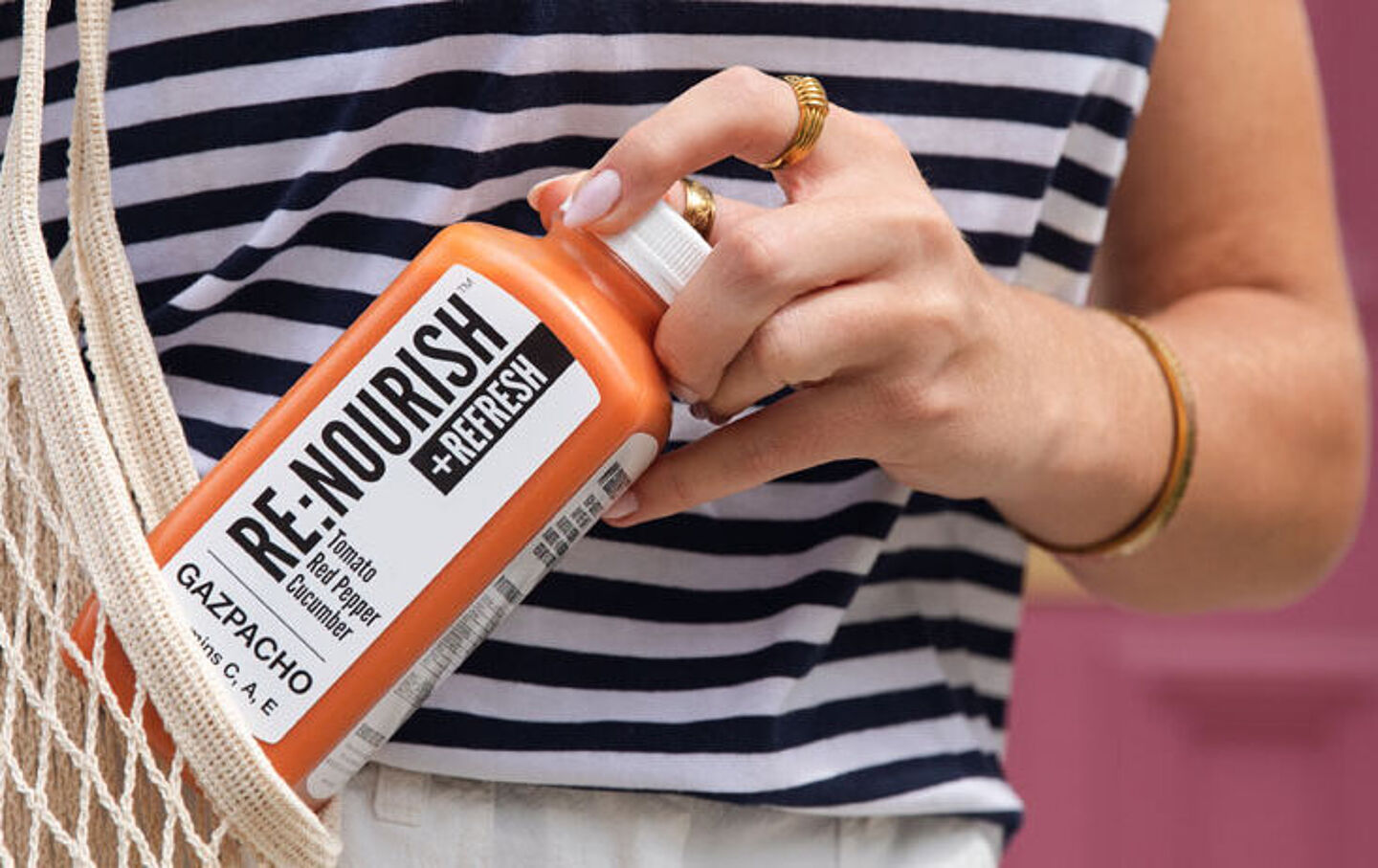 Woman's hand takes a bottle from a shopping bag