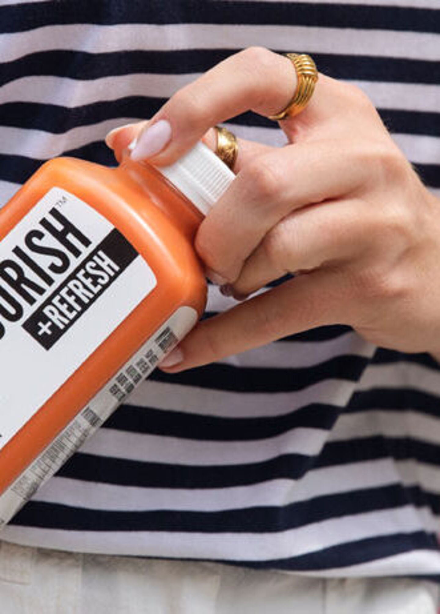 Woman's hand takes a bottle from a shopping bag